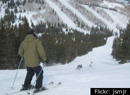 A skier helps a snowboarder find his balance at Park City Mountain.