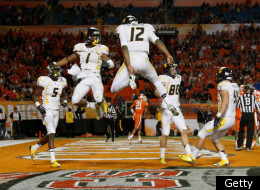 MIAMI GARDENS, FL - JANUARY 04: Tavon Austin #1 and Geno Smith #12 of the West Virginia Mountaineers celebrate after Austin caught a 37-yard touchdown reception thrown by Smith in the third quarter against the Clemson Tigers during the Discover Orange Bowl at Sun Life Stadium on January 4, 2012 in Miami Gardens, Florida. (Photo by Mike Ehrmann/Getty Images)