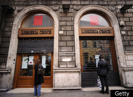 People look at posters in the shop window of Libreria Croce, a famous bookshop of Rome on December 2, 2011. Libreria Croce, a book store that was the biggest in Rome when it opened in 1945 but was forced to shut down this month due to the prolonged financial crisis. (Getty)