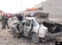 Iraqi security forces inspect the scene of a car bomb attack outside the northern city of Mosul, 225 miles (360 kilometers) northwest of Baghdad, Iraq, Monday, Jan. 16, 2012. (AP)