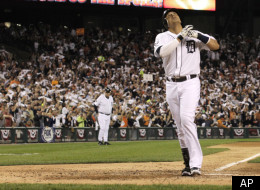 Detroit Tigers designated hitter Victor Martinez reacts at home plate after scoring on a solo home run in the fourth inning of Game 3 of baseball's American League championship series against the Texas Rangers, Tuesday, Oct. 11, 2011, in Detroit. (AP Photo/Charlie Riedel)