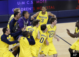 Michigan guard Zack Novak (0), forward Evan Smotrycz (23), and guard Matt Vogrich (13) celebrate with teammates including guard Trey Burke (3) and guard Tim Hardaway, Jr., right, after an NCAA college basketball game against Michigan State, Tuesday, Jan. 17, 2012, at Crisler Center in Ann Arbor, Mich. Michigan won 60-59. (AP Photo/Tony Ding)
