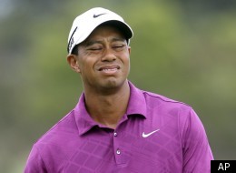 U.S. golfer Tiger Woods reacts to a put on the 3rd green during the first round of the Australian Open golf tournament in Sydney, Australia, Thursday, Nov. 10, 2011. (AP Photo/Rob Griffith)