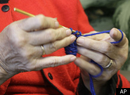 In this Friday, Nov. 11, 2011 photo, Bev Meska of Michigan City, Ind. works on a scarf in Indianapolis. Meska crocheted about 250 scarves for a