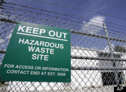 A sign is posted at an ongoing cleanup pump and treatment center operated by Shaw Corp. on lot 203 at Camp Lejeune, N.C., Wednesday, May 9, 2007.