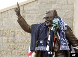 A man kneels in prayer near a statue of legendary Penn State football coach Joe Paterno, Wednesday, Jan. 25, 2012, in State College, Pa. Paterno's family along with former players and assistant coaches made their way Wednesday to a campus spiritual center for the revered coach's funeral service, a moment of private mourning during a week in which thousands from Penn State were saying goodbye. Paterno died Sunday, Jan. 22. (AP Photo/Gene J. Puskar)