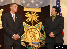 Eric M. Jones, left, and Steve DeChiaro stand in front of the Medal of Valor during an awards ceremony at the Pentagon in Washington Monday, July 15, 2002. Both men were honored for their efforts after the Sept. 11 terrorist attack. The Medal of Valor, the highest award given to civilians by the Department of Defense, recognizes acts of heroism in the face of danger. (AP Photo/Evan Vucci)