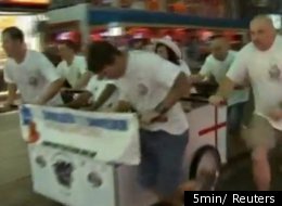 One of 30 teams participating in the fourth annual Pattaya Bed Race in Pattaya, Thailand. Teams of up to six people have to push a bed one mile in order to win.