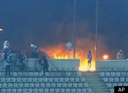 This image made from Egypt TV shows fans and a fire at a soccer stadium in Port Said, Egypt, Wednesday, Feb.1, 2012. Dozens of Egyptians were killed Wednesday in violence following a soccer match in Port Said, when fans flooded the field seconds after the match against a rival team was over, Egypt's Health ministry said. It was one of the worst incidents of sports violence in Egypt in decades. A security official and a medic said fans of the home team, Al-Masry, swarmed the field after a rare 3-