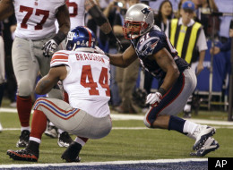 New York Giants running back Ahmad Bradshaw (44) scores on a touchdown in front of New England Patriots linebacker Jerod Mayo, right, during the second half of the NFL Super Bowl XLVI football game, Sunday, Feb. 5, 2012, in Indianapolis. (AP Photo/Matt Slocum)