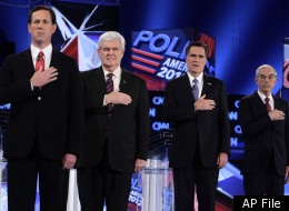 Republican presidential candidates, from left, former Pennsylvania Sen. Rick Santorum, former House Speaker Newt Gingrich, former Massachusetts Gov. Mitt Romney and Rep. Ron Paul, R-Texas, stand during the National Anthem at the Republican presidential candidates debate at the University of North Florida in Jacksonville, Fla., Thursday, Jan. 26, 2012. (AP Photo/Paul Sancya)