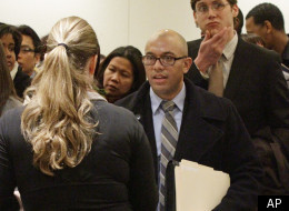 In this Jan. 25, 2012 photo, job seekers attend a job fair held by JobEXPO, a company hosting hiring events, in New York.