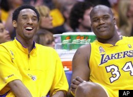Los Angeles Lakers' Kobe Bryant, left, and teammate Shaquille O'Neal laugh as they watch the end of their game against the Sacramento Kings from the bench, Wednesday night, April 17, 2002, in Los Angeles. The Lakers won 109-95. Let's sum up the NBA playoffs with a five-word question: Can anybody beat the Lakers? (AP Photo/Mark J. Terrill)