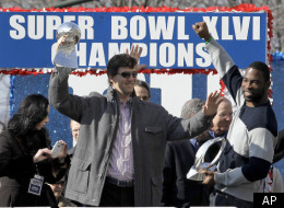 Fans cheer as the New York Giants arrive back at the Giants NFL football training facility Monday, Feb. 6, 2012, in East Rutherford, N.J. A day earlier, the Giants defeated the New England Patriots in Super Bowl XLVI. (AP Photo/Bill Kostroun)