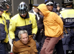 Police remove demonstrators who tried to block the entrance to the federal building during an anti-war protest Friday, March 21, 2003, in Chicago. (AP Photo/Stephen J. Carrera)