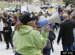 A woman uses a megaphone to address Occupy Denver protesters at the City and County Building in Denver, on Thursday, Nov. 17, 2011. (AP Photo/Ed Andrieski)
