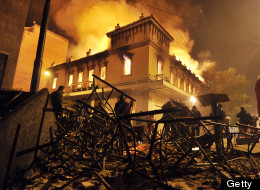 A fire engulfs a store during clashes between protesters and riot police near the Greek parliament in Athens on February 12, 2012. (Photo credit should read LOUISA GOULIAMAKI/AFP/Getty Images)
