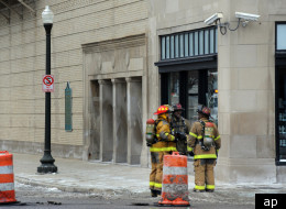 Firefighters at the scene of a Sunday explosion in the sewer under Detroit's Orchestra Hall.