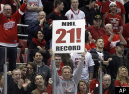 Fans celebrate the Detroit Red Wings' 3-1 win over the Dallas Stars in an NHL hockey game in Detroit, Tuesday, Feb. 14, 2012. Detroit set an NHL record with 21 consecutive home victories. (AP Photo/Paul Sancya)