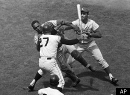 San Francisco Giants pitcher Juan Marichal (27) swings a bat at Los Angeles Dodgers catcher John Roseboro in the third inning at Candlestick Park in San Francisco, Calif., on Aug. 22, 1965 when Marichal apparently felt Roseboro had thrown too close to his head. Los Angeles pitcher Sandy Koufax, rear, tries to break up the fight. Marichal was ejected and Roseboro was treated for facial cuts after the incident. (AP Photo/Robert H. Houston)