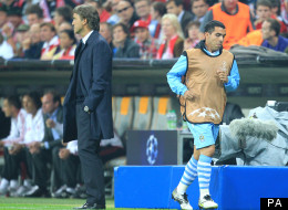 Walk on by: Carlos Tevez jogs past Roberto Mancini during that infamous night at the Allianz Arena