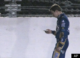 Drivers, from left, Greg Biffle, Dale Earnahdrt Jr, Landon Cassill and Joey Logano wait for Brad Keselowski, right, as they walk down the track toward the fire that caused a red-flag delay in the NASCAR Daytona 500 auto race at Daytona International Speedway in Daytona Beach, Fla., Monday, Feb. 27, 2012. (AP Photo/Bill Friel)