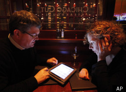 In this photo taken Wednesday, Dec. 1, 2010, Keith Peg Bragg of Chicago view the wine list on an iPad at Chicago Cut steakhouse in Chicago. The restaurant is just one eatery of several across the U.S. that have started uploading menus and wine lists to the digital devices. (AP)
