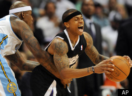 Denver Nuggets forward Al Harrington, left, fouls Sacramento Kings guard Isaiah Thomas, right, in the second half of an NBA basketball game in Denver on Monday, March 5, 2012. The Nuggets won 119-116 in overtime. (AP Photo/Chris Schneider)
