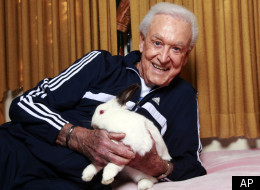 In this Tuesday, Dec. 13, 2011 photo, retired game show host Bob Barker holds his 8-year-old rabbit Mr. Rabbit at his home in Los Angeles. Barker would like his rabbit to spend more time in its litter box. And Mr. Rabbit's resolution for Barker? What else?