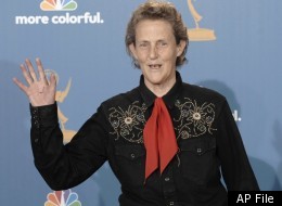 Temple Grandin waves in the press room after the
