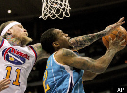 Denver Nuggets center Chris Andersen (11) fouls New Orleans Hornets forward Lance Thomas (42) during the second quarter of an NBA basketball game Friday, March 9, 2012 in Denver. (AP Photo/Barry Gutierrez)