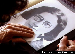 Simone Weil's niece Sylvie Weil flips though family photo album. (Credit: Thomas Torres Cordova.)
