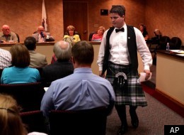 William Carruba, center, a senior at Granite City, Ill. High School, returns to his seat after asking the Community Unit 9 School Board to lift its restriction on wearing a kilt to his high school prom on Tuesday March 27, 2012. The Granite City School Board on Tuesday said no a second time to Carruba's request to wear the frock he bought made out of his family's tartan. School administrators say the kilt is nontraditional and don't fit into the district's dress code. Carruba says he understands