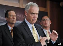 Sen. Ron Johnson (center) discusses the budget at the Capitol.