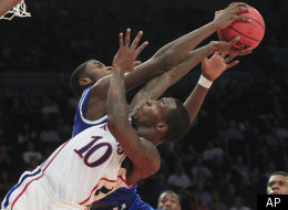 Kansas' Tyshawn Taylor (10) has his shot blocked by Kentucky's Michael Kidd-Gilchrist during the second half of an NCAA college basketball game, Tuesday, Nov. 15, 2011, at Madison Square Garden in New York. Kentucky won 75-65. (AP Photo/Frank Franklin II)