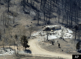 Remnants of structures are all that stand in the wake of the Lower North Fork Wildfire burning in the foothills community of Conifer, Colo., southwest of Denver on Tuesday, March 27, 2012. Firefighters are now able to actively battle the blaze on the ground that started on Monday and has already destroyed at least 16 homes in the rugged terrain. (AP Photo/David Zalubowski)