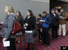 In this March 7, 2012 file photo, job seekers stand in line during the Career Expo job fair in Portland, Ore.