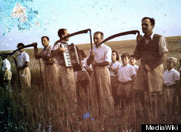 Members of Kibbutz Givat Haim Meuchad with scythes at harvest of the Omer in Israel.