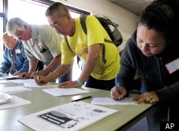 Job candidates fill out forms for employment interviews at the Goodwill Southern California job fair in Bell, Calif. on Friday, March. 9