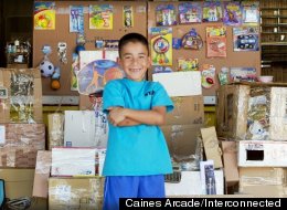 Caine Monroy stands in front of his small business, Caine's Arcade.