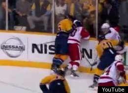 Shea Weber of Nashville slams Red Wings star Henrik Zetterberg's head into the boards.