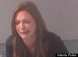 Attorney Jennifer Little breaks down as officers take her mugshot after a DUI arrest on Thursday.