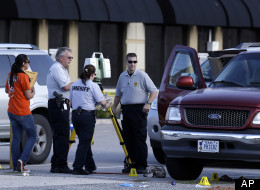 Members of the Montgomery County Sheriff's Department work the crime scene where a mother was killed and her baby was kidnapped Tuesday, April 17, 2012, in Spring, Texas. A newborn boy was abducted from his screaming mother after she was repeatedly shot outside a suburban Houston pediatric center on Tuesday, according to investigators searching for the suspected shooter who sped off with the infant in a blood-stained Lexus.