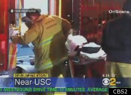 Suspect Jeremy Hendricks is being loaded into an ambulance after being shot by a USC public safety officer. (CBS2)