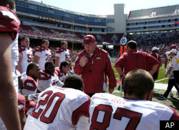 Arkansas coach Bobby Petrino, center, talks with members of the white team offense during the first half of a college intrasquad football game in Fayetteville, Ark., Saturday, April 16, 2011. (AP Photo/April L. Brown)
