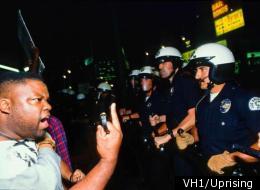 A protester confronts police during the L.A. riots in 1992.