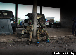 Soldiers and a mechanic at the Katindo military camp in Goma, Congo. (Photo: Melanie Gouby)