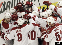 Phoenix Coyotes goalie Mike Smith (41) celebrates with teammates after the Coyotes defeated the Chicago Blackhawks 4-0 in Game 6 of an NHL hockey Stanley Cup first-round playoff series in Chicago, Monday, April 23, 2012. (AP Photo/Nam Y. Huh)