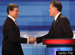 Republican presidential candidates Texas Gov. Rick Perry (L) and former Massachusetts Gov. Mitt Romney chat following the Fox News Channel debate at the Sioux City Convention Center on December 15, 2011 in Sioux City, Iowa.