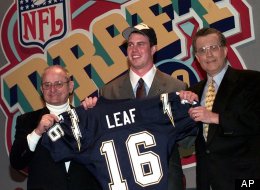 Ryan Leaf, center, of Washington State gets help holding up his San Diego Chargers jersey by Chargers owner Alex Spanos, left, and NFL commissioner Paul Tagliabue as the second pick overall in the 1998 NFL Draft.
